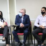 O presidente do Conselho está sentado de máscara entre dois colaboradores das Unidades Regionais. Uma mulher à esquerda e um homem à direita.