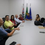A imagem traz representantes do CRMV-SP, o secretário do Meio Ambiente e equipe sentados à mesa, durante reunião, em Ribeirão Preto.