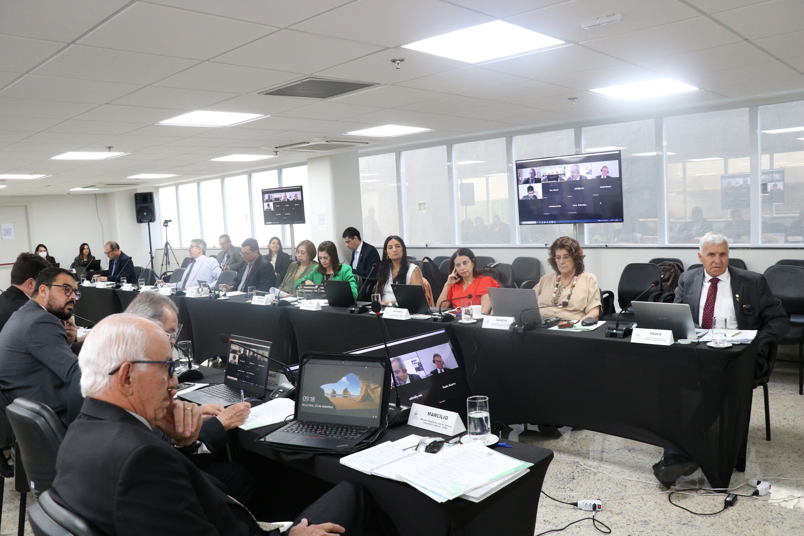 Na foto, membros do plenário estão sentados na sala.