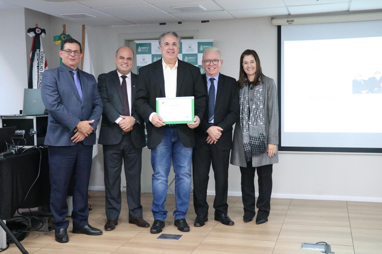 No palco, os membros da Diretoria Executiva do CRMV-SP posam ao lado de um dos integrantes da Comissão Técnica de Representantes Regionais, homenageado com certificado em reconhecimento ao trabalho desempenhado.