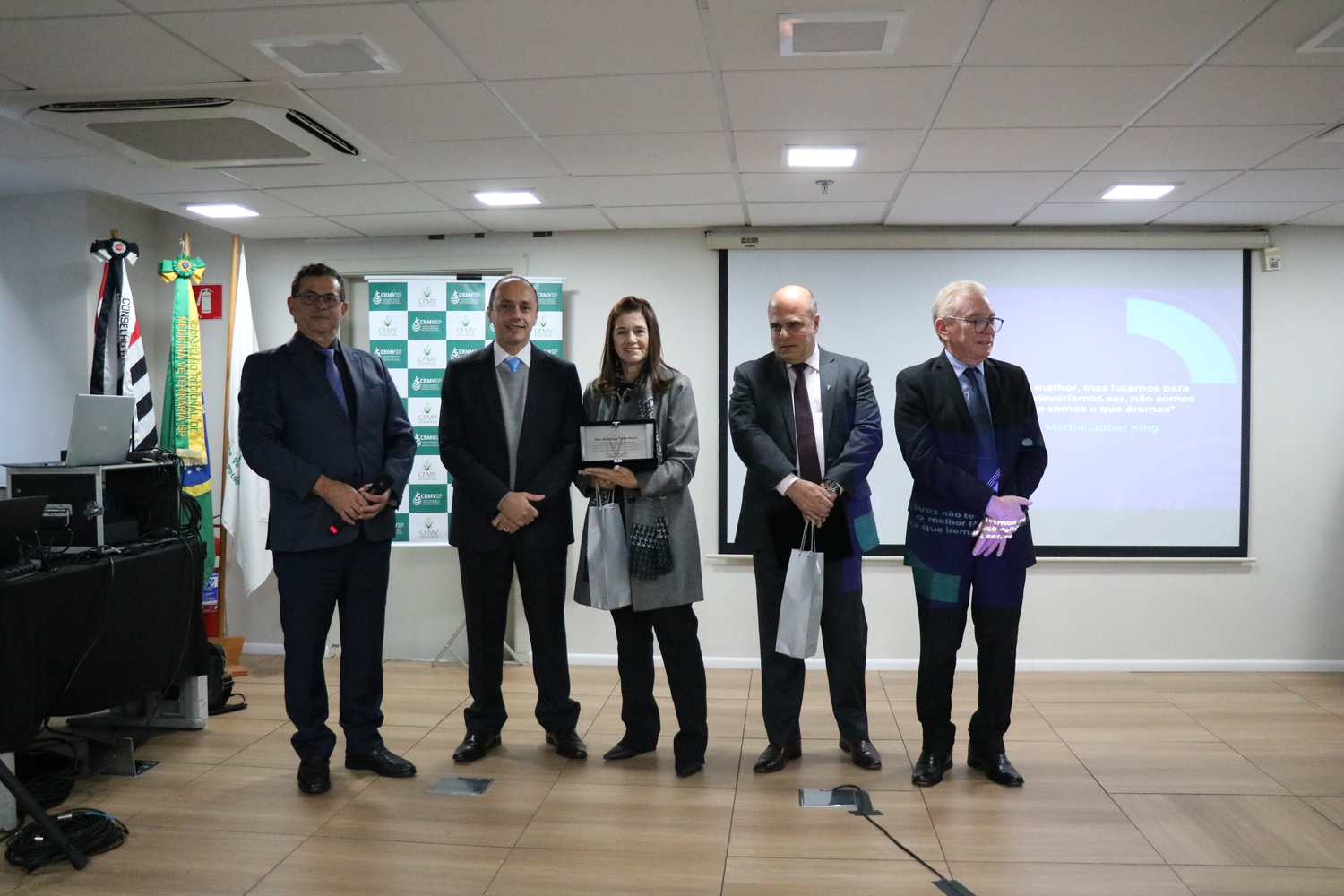 A tesoureira do CRMV-SP, ao lado dos membros da Diretoria Executiva, recebe placa em homenagem ao trabalho prestado no Conselho.