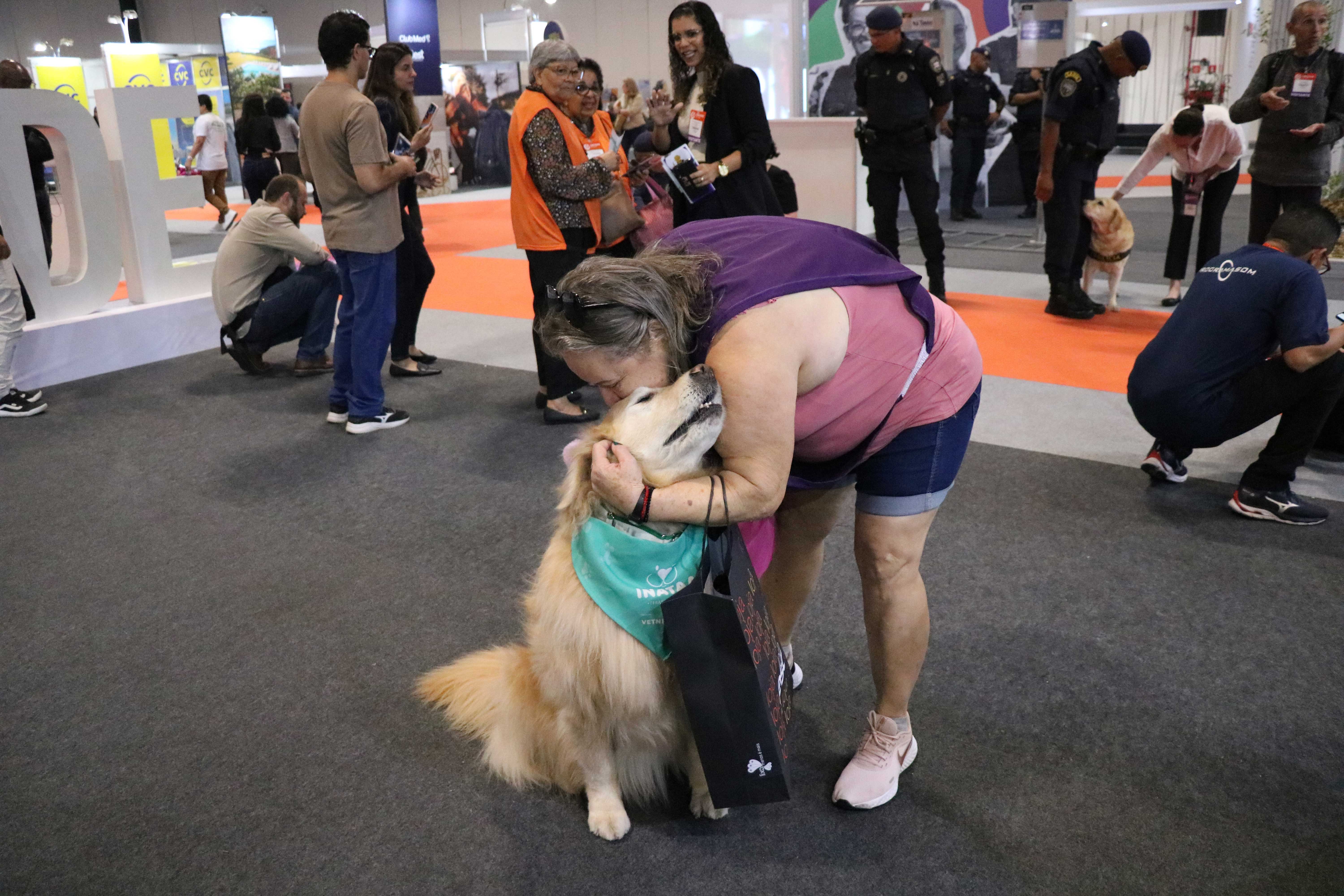 mulher beijando cão no evento