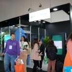 Pessoas reunidas frente a porta do evento.