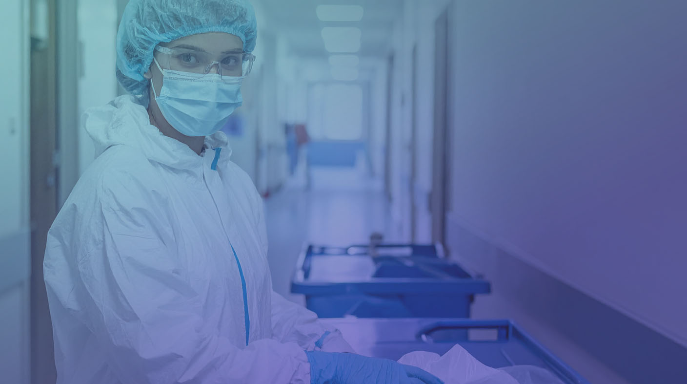 Mulher usando jaleco branco e mascara n95 e óculos de proteção em laboratório.