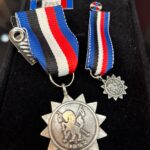 imagem de uma medalha de honraria.
