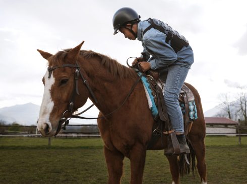 young-boy-learning-how-ride-horse